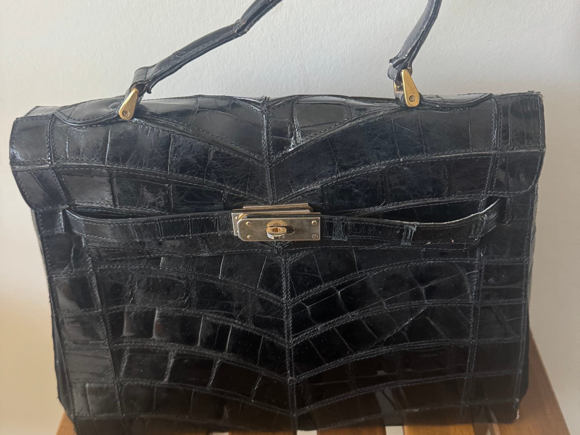 Black crocodile leather handbag with gold hardware