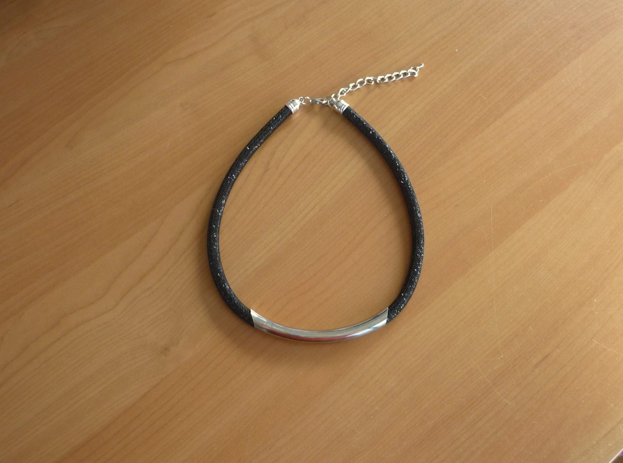Ronde zwarte net strass ketting met zilverkleurige brede hanger